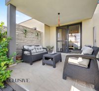 The terrace of a family house in Oľdza with garden seating and greenery.