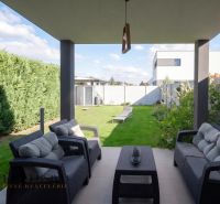 The terrace of a family house in Oľdza with comfortable seating and a view of the garden.