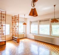 Interior of a family house with wooden decor, an original partition wall, and wicker lights.