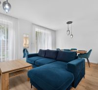 Living room in a family house with a blue sofa and a wooden decor floor.