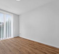 An empty room in a family house with white curtains and a wooden decor floor.
