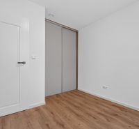 Interior of a family house with white walls and a floor with a wood decor.