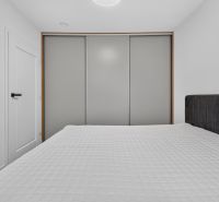 Bedroom with a bed and a built-in wardrobe in a family house.