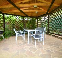 Garden gazebo near Kladnianska Street in Bratislava - Ružinov with a concrete area and seating.