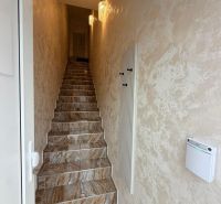 A narrow staircase space in a 3-room apartment with a patterned carpet.