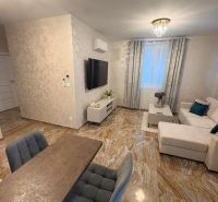 Living room in a 3-room apartment with glossy tiles and comfortable seating.