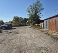 Garages on Jantárová Street in Košice - Juh district, gravel and greenery.