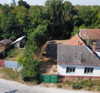 A family house on St. Florian Square, Krakovany, surrounded by greenery and a children's playground.