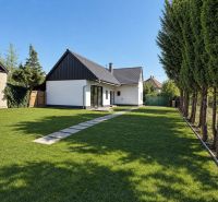 A family house on St. Florian Square in Krakovany with a garden and a curbside sidewalk.