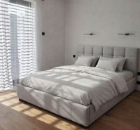 Bedroom in a family house with a large bed, curtains, and a floor with a wooden decor.