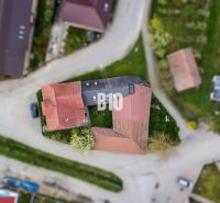 An aerial view of a family house in Púchov surrounded by roads and green areas.