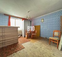 The interior of a family house with furniture and blue wallpaper on the walls.