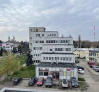Office building on Záhradnícka Street in Komárno with parking and greenery.