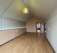 Interior of a cabin with a wood-patterned floor and an impressive pendant light.