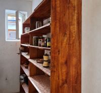 A pantry in a family house with shelves and stored preserves.