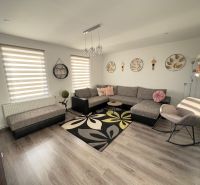 Living room of a family house with wall and floor decor in wood design.