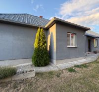 A family house in Blatné Revištia with a manicured lawn and a wall in a gray shade.
