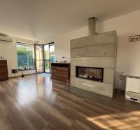 Living room in a family house with a fireplace and a wooden decor floor.
