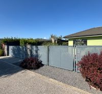 A family house on Figová Street in Bernolákovo with a metal fence and a landscaped garden.