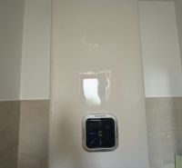 Electric boiler in a family house with touch control and digital display.