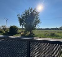 Sunny day on Fig Street in Bernolákovo with a view from the family house to nature.