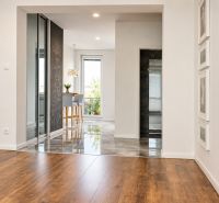 Living area in a 3-room apartment with wood-patterned flooring and a view.