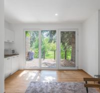 Interior with large windows, kitchen unit, and wooden decor flooring. Recreational plots.