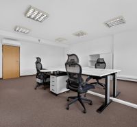 Offices with white desks and black chairs.