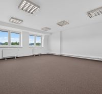 Spacious offices with windows and white walls, suitable for a work environment.