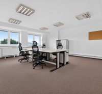 Offices with rolling chairs, white desks, and a bulletin board, floor with wood decor.