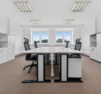 Spacious offices with desks, black chairs, and storage cabinets, floor with wood decor.