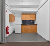 Offices with white walls, a kitchenette, and fire equipment.