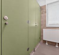 Green doors in offices, radiator and window with a blind.