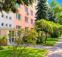 Apartment building on Rumančeková Street in Bratislava - Ružinov, surrounded by greenery and trees.