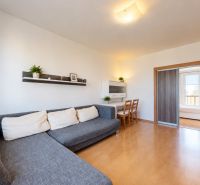 Living room in a 3-room apartment with a corner sofa and sliding doors.