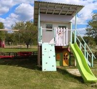 Children's playground with a slide in the garden at Tatranská 201 in Zlaté Moravce.