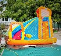 Inflatable attraction in the garden in Zlaté Moravce with a swing and a slide.
