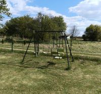 A children's swing in the middle of the garden at Tatranská 201 in Zlaté Moravce.