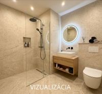Bathroom in a studio apartment with a glass shower enclosure and a backlit mirror.