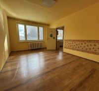 A room with a wooden floor decor in a studio apartment and yellow walls.