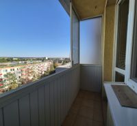 A balcony of a studio apartment with a view of Bystrická Street in Pezinok, sunny day.