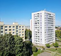 View of apartment buildings and greenery in Trnava, ideal for a 3-room apartment.