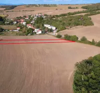 Agricultural and forest land in Podhájska, with views of the surrounding fields and greenery.