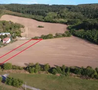 Agricultural and forest land in Podhájska with visible boundaries, surrounded by forests.