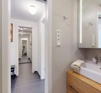 Bathroom interior in a 2-room apartment with a sink and a mirrored cabinet.