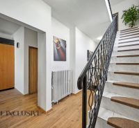 A staircase with white steps and a wooden decor floor in a family house.