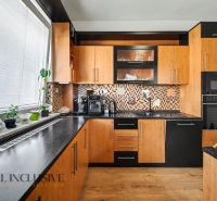 A kitchen in a family house with wooden decor and modern equipment.