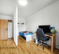 Children's room in a family house with a desk and a wooden decor floor.