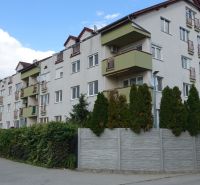 An apartment building on Družstevná Street in Hamuliakovo surrounded by greenery.