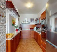 A kitchen with stone cladding and modern appliances in a 4-room apartment.